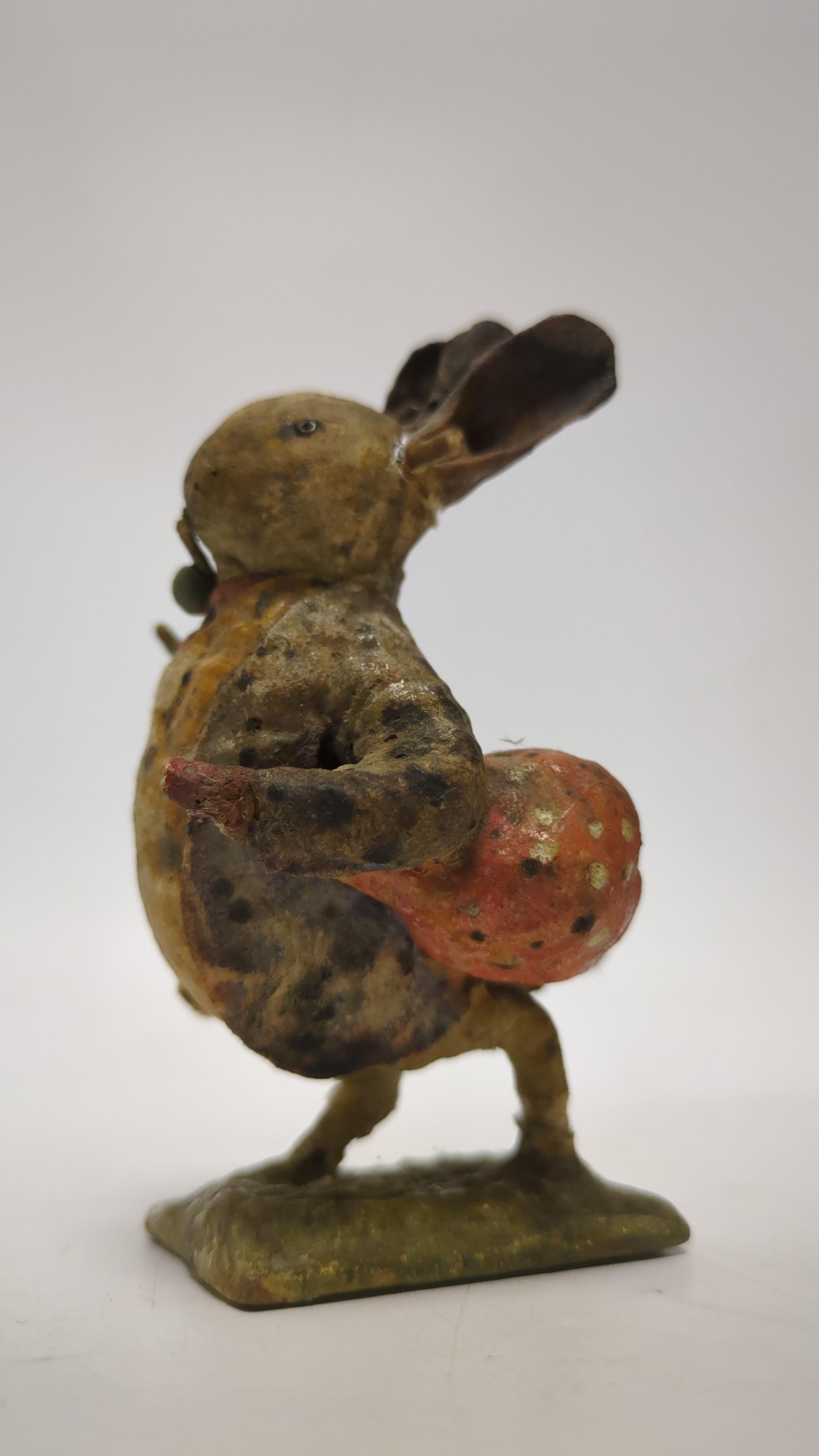 An F. Warne papier-mâché Beatrix Potter figure of Benjamin Bunny with pipe and red handkerchief bag, red and white F. Warne & Co. paper label to the base, dating it to pre-1917, 9cm high